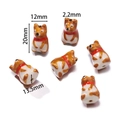 Macro view of handmade Shiba Inu ceramic beads with red scarf detail for DIY jewelry crafts - Puppy with Scarf