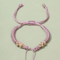 Detail of pink hand-woven bracelet with gold silk thread and adjustable sliding knot - Length approx. 12-25cm / Pink