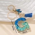 Portachiavi lettera G in resina glitterata blu con ciondolo farfalla e nappa - Blu G