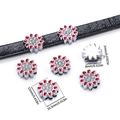Macro detail of red daisy alloy slider bead with sparkling rhinestones on leather strap - Red Daisy
