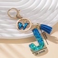 Portachiavi lettera J con farfalla blu e nappa in resina glitterata scintillante - Blu J