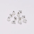 Macro detail of eleven bullet-shaped silver metal earring backs for DIY jewelry making - 5*6mm (200 Pieces/Pack) / Silver