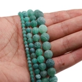 Macro view of green weathered agate beads showing unique crackle texture in hand - 6mm (62 Beads/String/21g) / Green