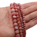 Detail of red weathered dragon vein agate loose beads held in hand for jewelry DIY - 6mm (62 Beads/String/21g) / Red