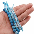 Close-up of blue weathered agate beads with ice crackle texture for DIY jewelry making - Blue