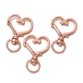 Three rose gold heart-shaped alloy lobster clasps with rotating swivel rings on white background - Heart Shape / 5 Pieces / Rose Gold