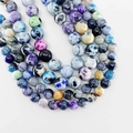 Polished natural fire agate round beads with vibrant blue spots for jewelry making - 6mm / Multicolor