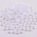 Macro shot of white flatback ABS pearls showing glossy texture for DIY crafts and jewelry - White / 4mm