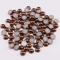 Macro view of flatback bronze pearls with smooth metallic finish and white bonding base - Coffee / 4mm