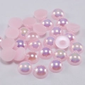 Close-up of pink iridescent flatback faux pearls with AB rainbow coating for DIY crafts - Light Pink