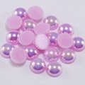 Close-up of pink iridescent flatback faux pearls with AB rainbow coating for DIY crafts - Light Purple