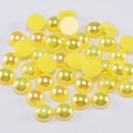 Detailed macro view of yellow half-round resin pearls with iridescent AB coating for DIY crafts - 4mm (300 Pieces/Pack) / Yellow