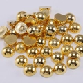 Detailed macro view of flatback gold-plated acrylic half pearls for DIY crafts and nail art - Gold