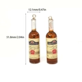 Miniature resin red wine bottle earrings with lifelike liquid effect and gold loops - Style 1 Wine Bottle
