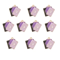 Close-up of alloy tarot pendants with purple enamel cat designs and golden metal frames - Magic Tarot Cards