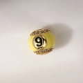 Detail of 12mm gold plated bead with yellow enamel and a sparkling number 9 crystal charm - Number 9 Billiard Style