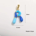 Macro detail of enamel letter R charm with dimensions 29mm by 15.5mm in gold plating - Letter R