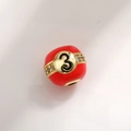 Macro shot of red enamel number 3 charm bead with gold plating and zircon inlay - Number 3 Billiard Style