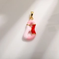 Macro detail of Letter B pendant with pink enamel and gold plating for DIY jewelry - Letter B