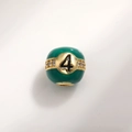Detailed macro view of number 4 green enamel charm bead with gold plating and white zircons - Number 4 Billiard Style