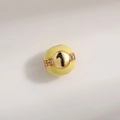 Detailed macro view of yellow enamel charm bead with sparkling number 1 and crystals - Number 1 Billiard Style / Light Yellow