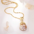 Detailed macro view of a baroque pearl necklace with a golden maple leaf and diamond inlay - Baroque Pearl (Leaf Clasp)