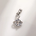 Macro shot of silver S925 planet pendant with a sparkling zircon and heart detail - Planet Design Style (Copper White Gold Plated Pink Zirconia A0211)