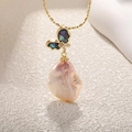 Detailed close-up of a baroque pearl necklace featuring a colorful butterfly pendant - Black Iridescent Butterfly Baroque Pearl (Ivory)