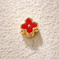 Macro shot of gold-plated four-petal flower bead with red enamel for DIY jewelry - Red White Shell Flower