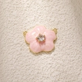 Macro detail of pink daisy flower charm with cubic zirconia and gold-plated connectors - Pink Camellia