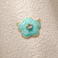 Macro view of mint green enamel daisy pendant with cubic zirconia inlay and dual rings - Blue Camellia