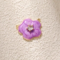 Macro detail of purple enamel flower charm with central zircon and gold plated finish - Purple Camellia