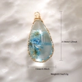 Macro view of teardrop pendant with blue dried flowers and golden wire filigree edges - Transparent Resin Blue Dried Flower Style