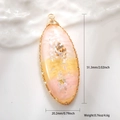 Macro view of teardrop resin pendant with shells, sequins, and size dimensions - Pink Conch Oval Style
