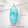 Detail of seashell resin drop pendant with gold wire wrap and measurement markings - Blue Conch Oval Style