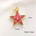 Macro shot of 12mm gold star pendant with red glitter inlay and small star accents - Star Charm (A0166)