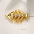 Detailed view of 14k gold fish bone pendant with black eye and sparkling zircon stones - Fishbone