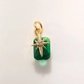 Macro detail of emerald-green rectangular crystal pendant with gold starburst and zircon - Gold Green A0210