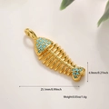 Macro detail of a 14k gold-plated fishbone pendant with blue beads and dimension specs - Turquoise Fish