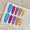 Detailed close-up of almond-shaped press-on nails featuring vibrant leopard print patterns - Extra Small (XS) / Long Almond Shape