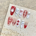 Handmade press-on nails set with red 3D rabbit, bow, and pearl details on rock background - XS