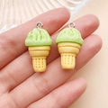 Close-up of two realistic light green resin ice cream cone charms with silver metal rings - Resin Food Play Ice Cream Cone (24762) / Green