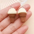 Close-up of resin ice cream cone charms with silver metal rings held in hand for scale - Resin Food Play Ice Cream Cone (24766) / Milk Yellow