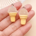 Close-up of resin ice cream pendants with colorful sprinkles on palm of hand - Resin Food Play Ice Cream Cone (24768) / Clear White