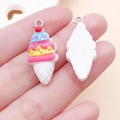 Macro shot of colorful resin strawberry ice cream pendants with silver metal rings - White Ice Cream (24492)