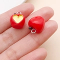 DIY jewelry charm featuring two red resin apple pendants with yellow heart patterns - Bitten Heart Apple (19700)