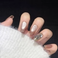 Macro shot of handmade cat-eye press-on nails with champagne gold glitter and rhinestones - XS / Iced Tea Pink Pomelo Short Coffin (1326)