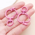 Close-up of matte pink apple-shaped zinc alloy lobster clasp with swivel ring - Rose Red