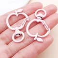 Detailed close-up of pink matte apple-shaped lobster clasps for DIY jewelry making - Light Pink
