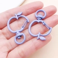 Close-up of matte lilac apple-shaped keychain hook with a 360-degree swivel ring - Purple